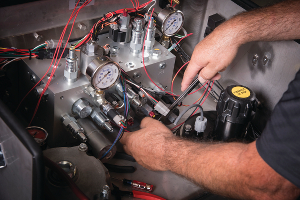 An image of Doug Winchester checking a hydraulic system.